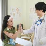 A sports injury doctor treating a child