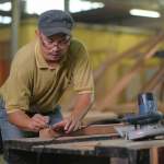 A carpenter is making furniture.
