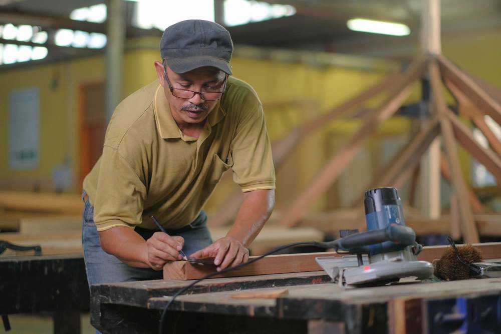 A carpenter is making furniture.